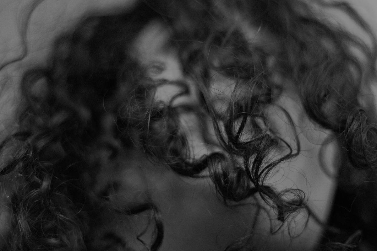 Close-up of natural hair braids showing dry ends vs. hydrated roots with Moisture Retention focus